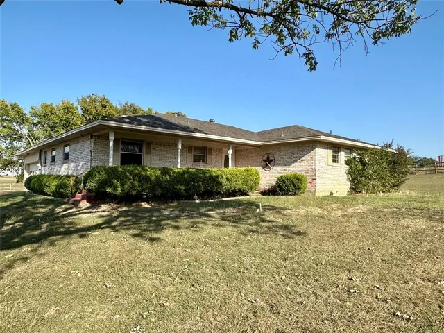 a view of a house with a tree in the background