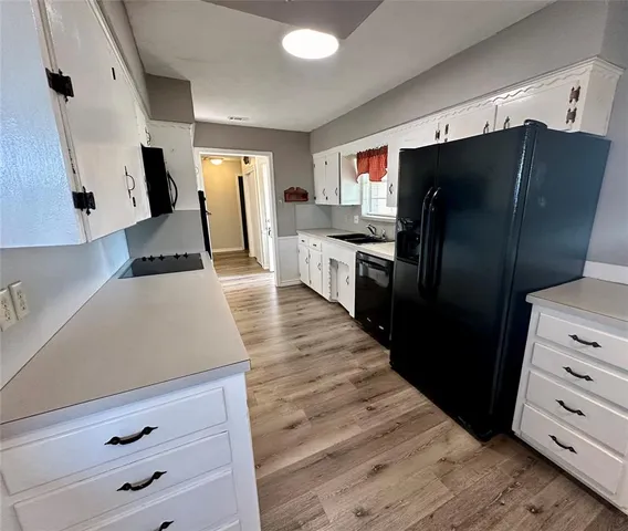 a kitchen with stainless steel appliances a refrigerator a stove and cabinets