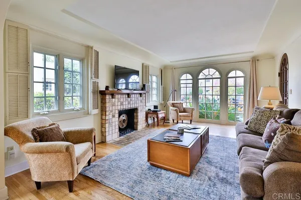 a view of a dining room with furniture a chandelier and wooden floor