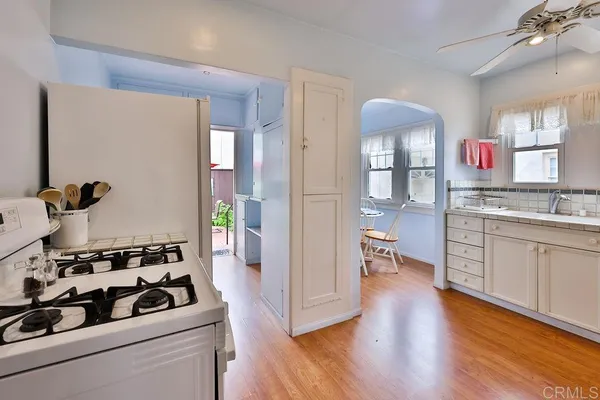 a kitchen with a white cabinets and window