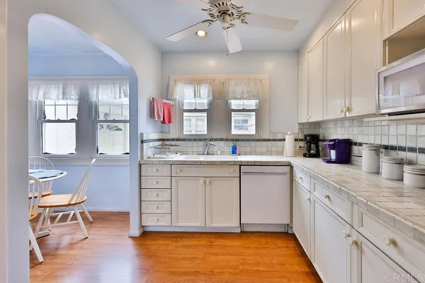 a kitchen with stainless steel appliances granite countertop a refrigerator and a stove