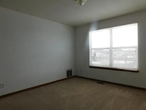 an empty room with a empty space and window