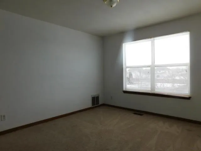an empty room with a empty space and window