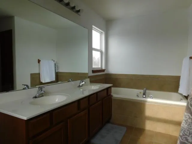 a bathroom with a toilet a sink and a window