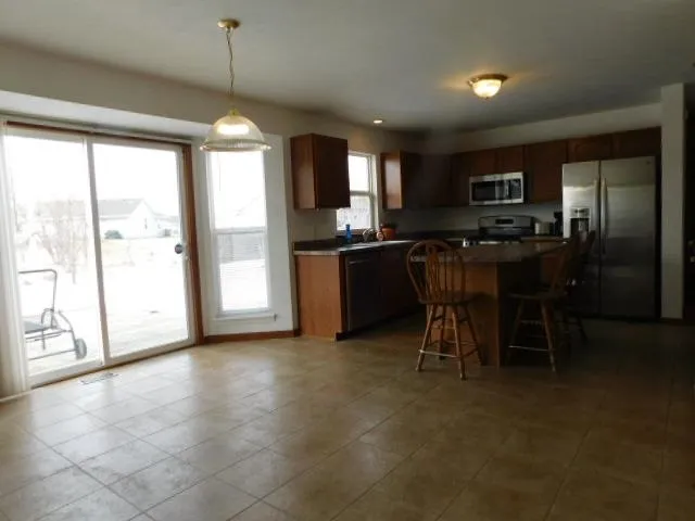 a view of kitchen with stainless steel appliances granite countertop counter space a sink and cabinets