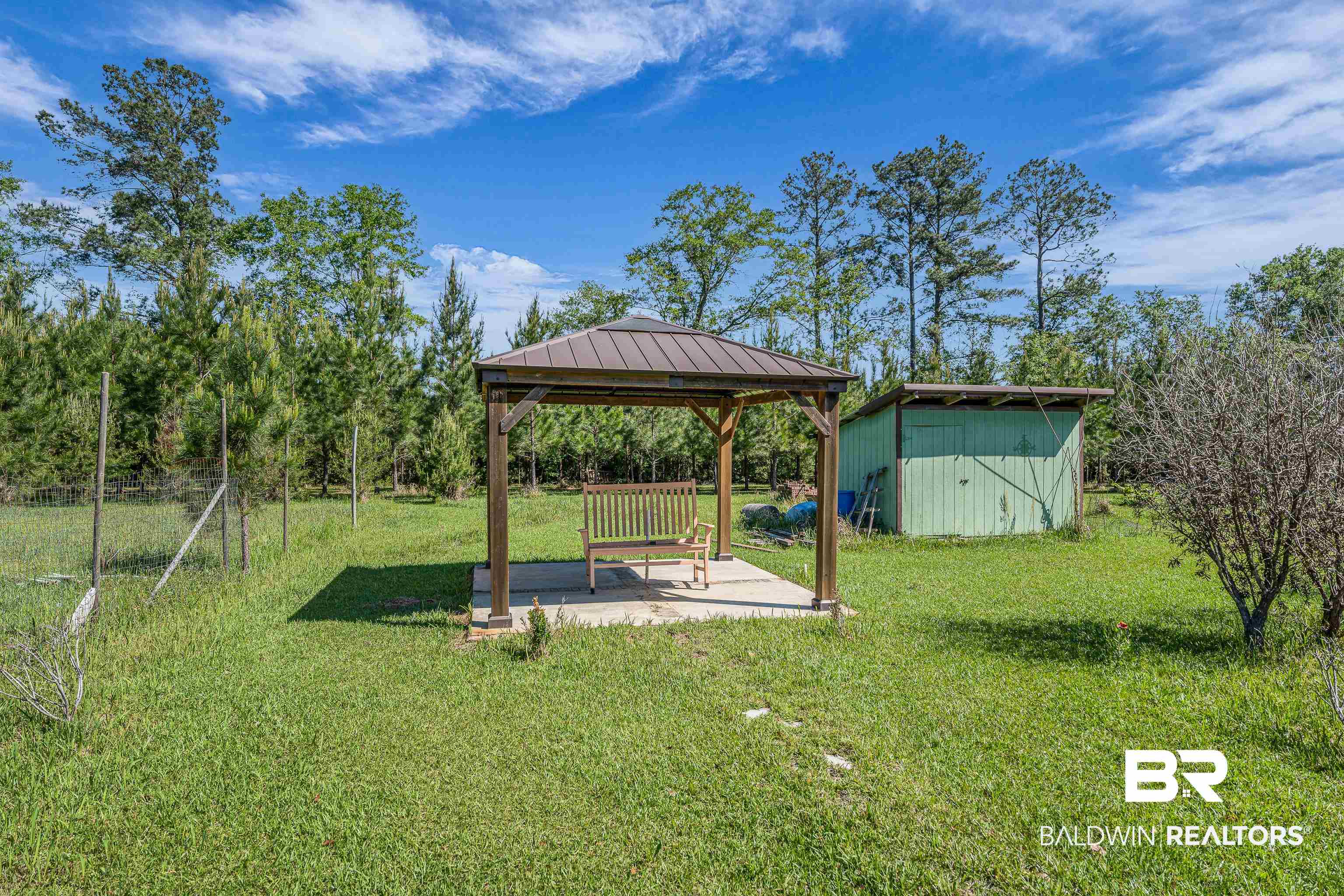 18255 Cactus Court Elberta, AL 36530 - Photo 48 of 53 View of grassy yard featuring a gazebo, a patio area, and a storage unit