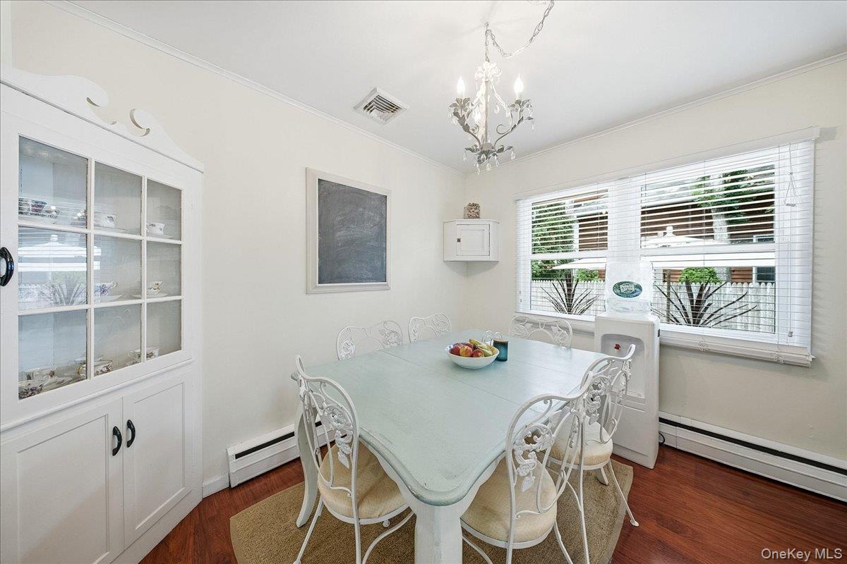 10 Graham Road Hampton Bays, NY 11946 - Photo 17 of 26 a view of a dining room with furniture window and wooden floor