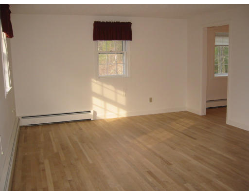 12 Cooper Pond Road Rowley, MA 01969 - Photo 9 of 9 an empty room with wooden floor and windows