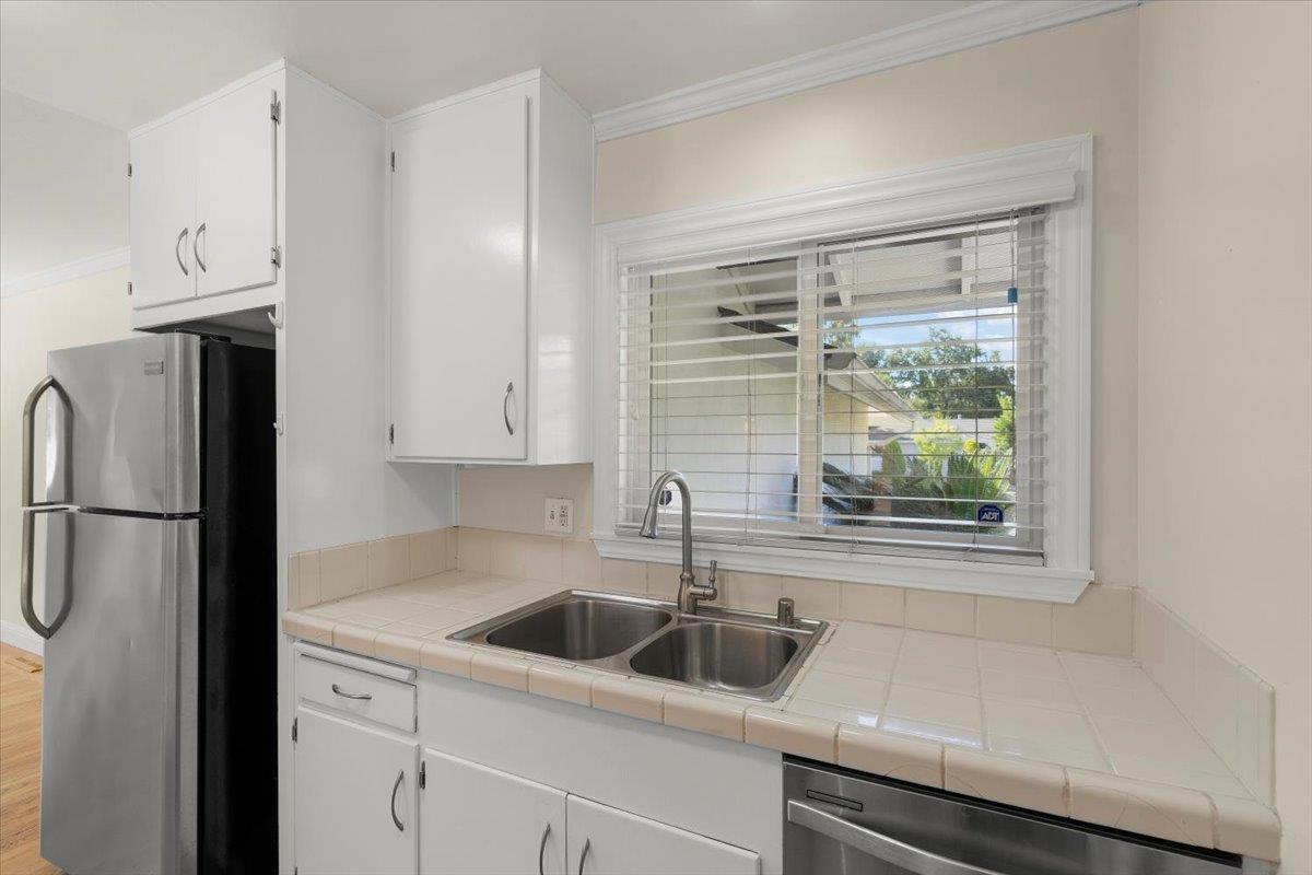 495 Giannini Drive Santa Clara, CA 95051 - Photo 7 of 21 a kitchen with stainless steel appliances a sink a refrigerator and a window