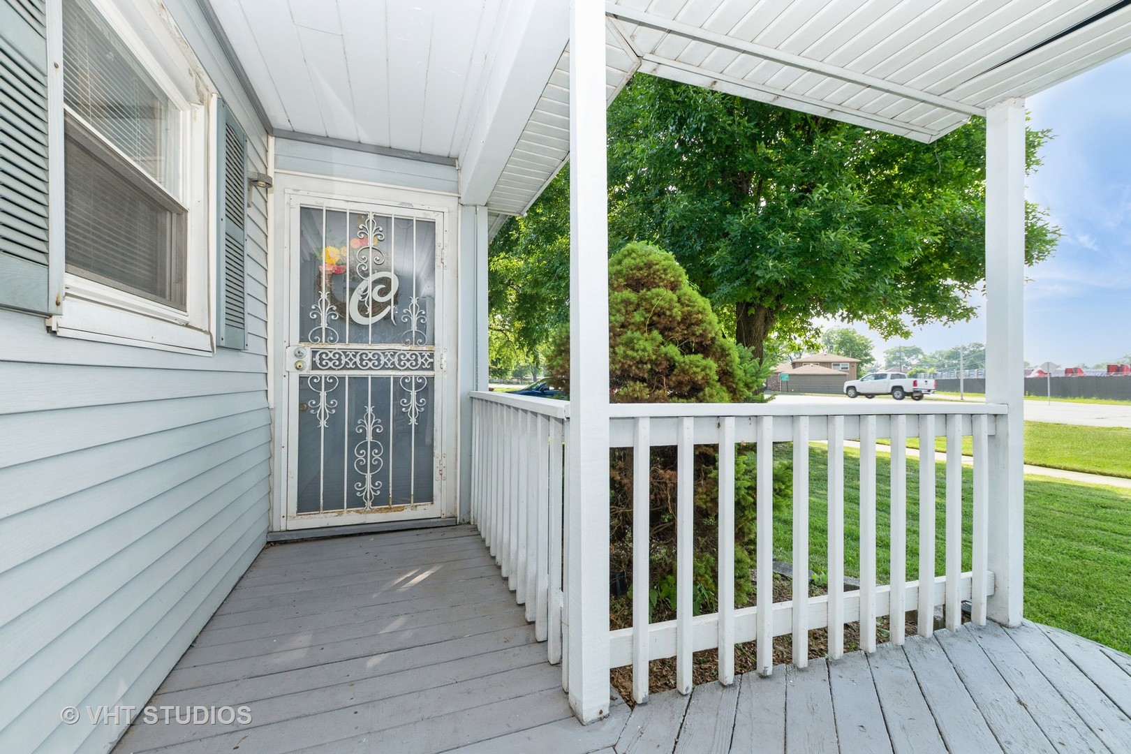 5101 State Road Burbank, IL 60459 - Photo 5 of 16 a view of a wooden house with a porch