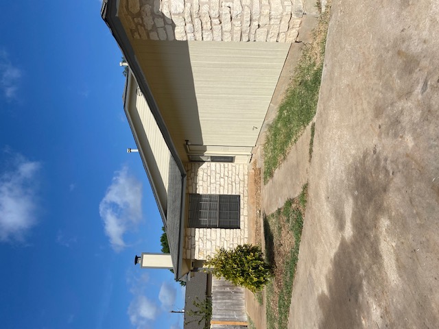 110 Verna Spur Georgetown, TX 78628 - Photo 3 of 7 A classic exterior with stone accents and a well-maintained roof.