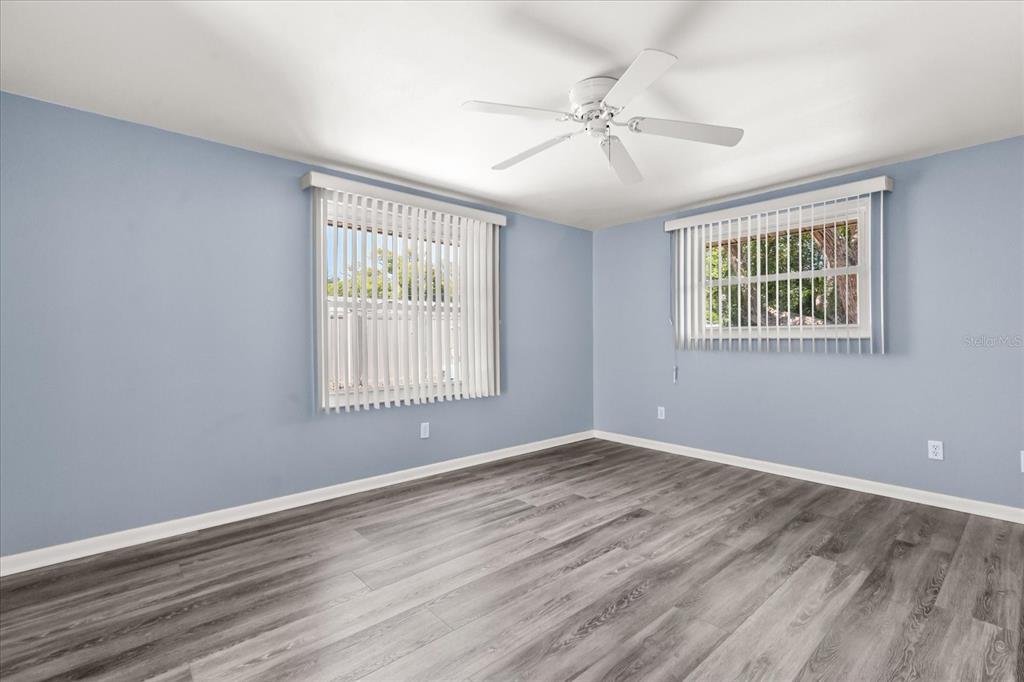 620 Jacaranda Street Dunedin, FL 34698 - Photo 12 of 30 a view of an empty room with wooden floor and a window