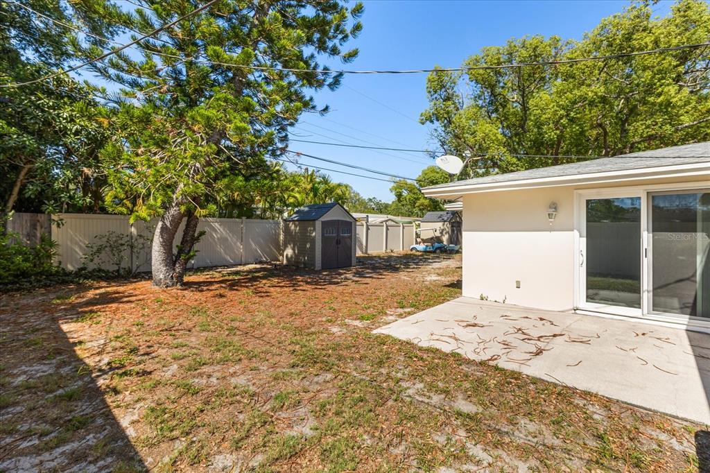 620 Jacaranda Street Dunedin, FL 34698 - Photo 22 of 30 a front view of a house with a yard and garage