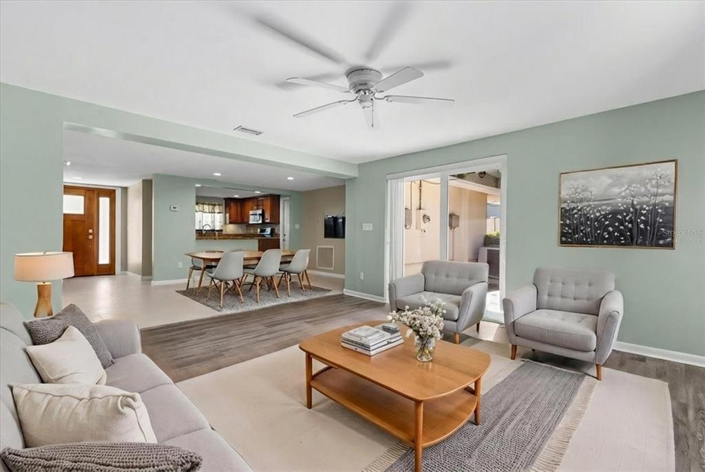 620 Jacaranda Street Dunedin, FL 34698 - Photo 6 of 30 a living room with furniture a rug and a chandelier