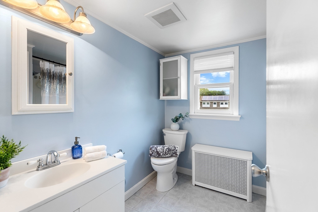 500 Lowell Street Lexington, MA 02420 - Photo 12 of 25 a bathroom with a toilet sink and mirror