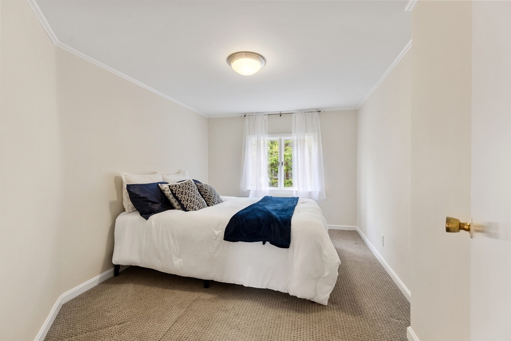 500 Lowell Street Lexington, MA 02420 - Photo 13 of 25 a bedroom with a bed and a window