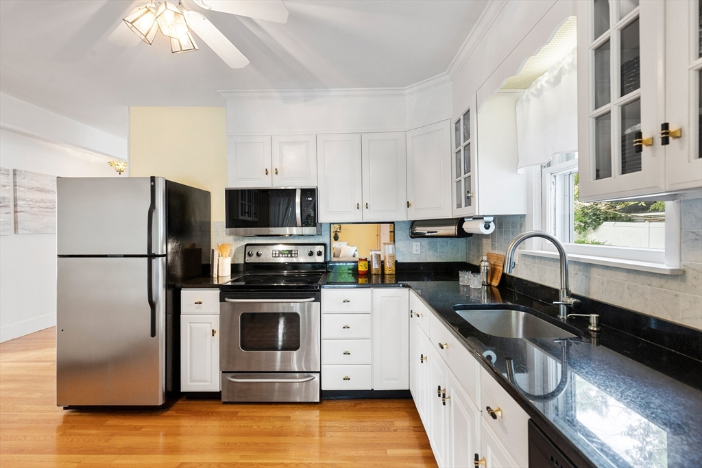 500 Lowell Street Lexington, MA 02420 - Photo 6 of 25 a kitchen with stainless steel appliances granite countertop a refrigerator sink and stove