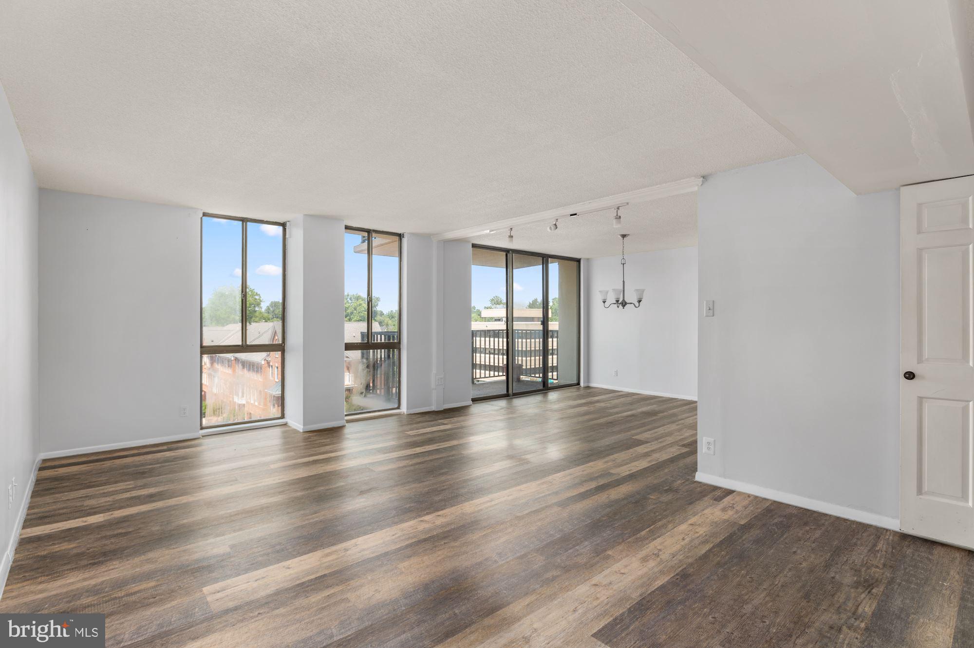 6800 Fleetwood Road, Unit 423 McLean, VA 22101 - Photo 1 of 27 a view of an empty room with wooden floor and a window