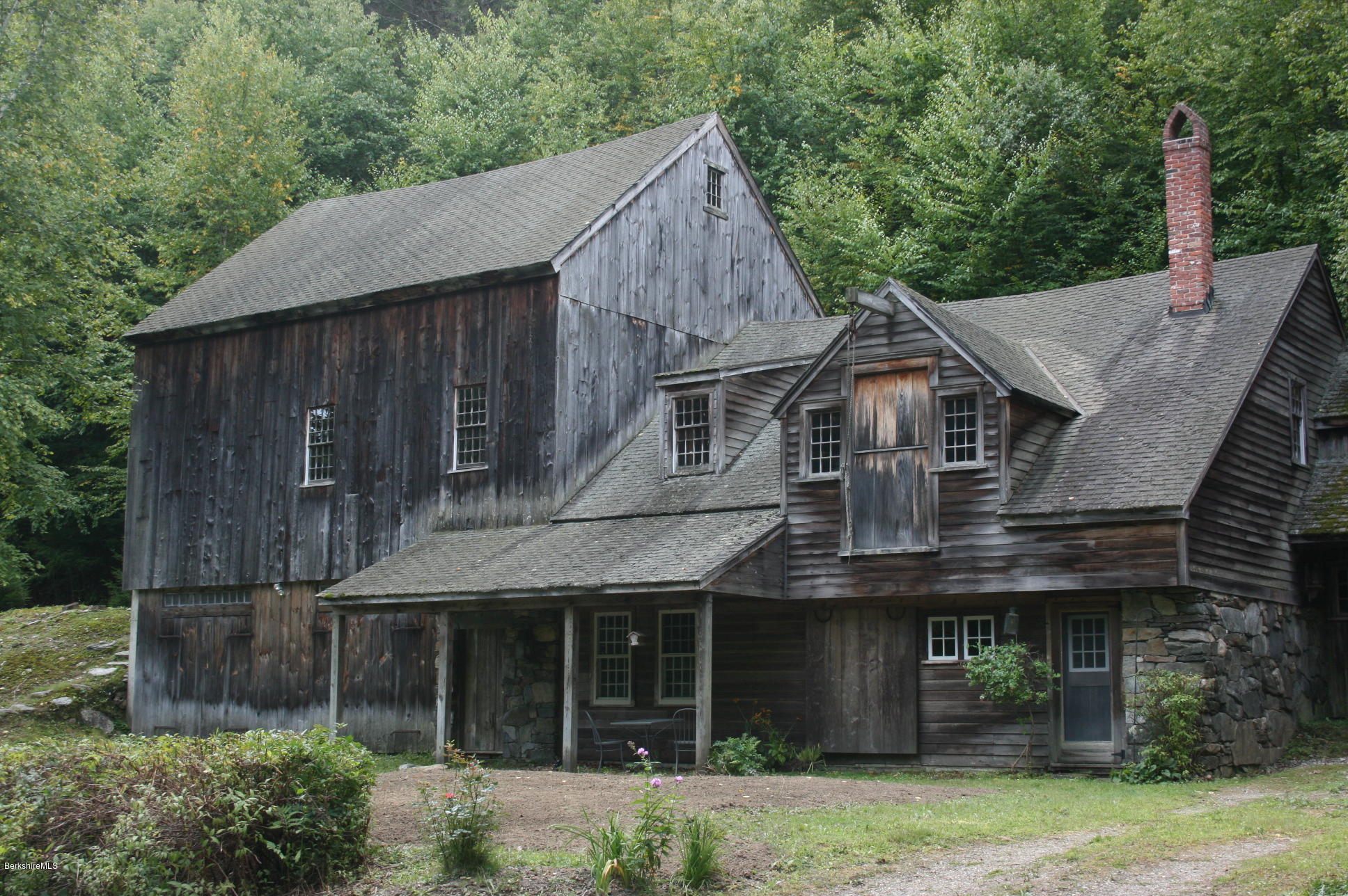 117 East River Road Middlefield, MA 01050 - Photo 2 of 20 a view of a white house with large windows and a small yard