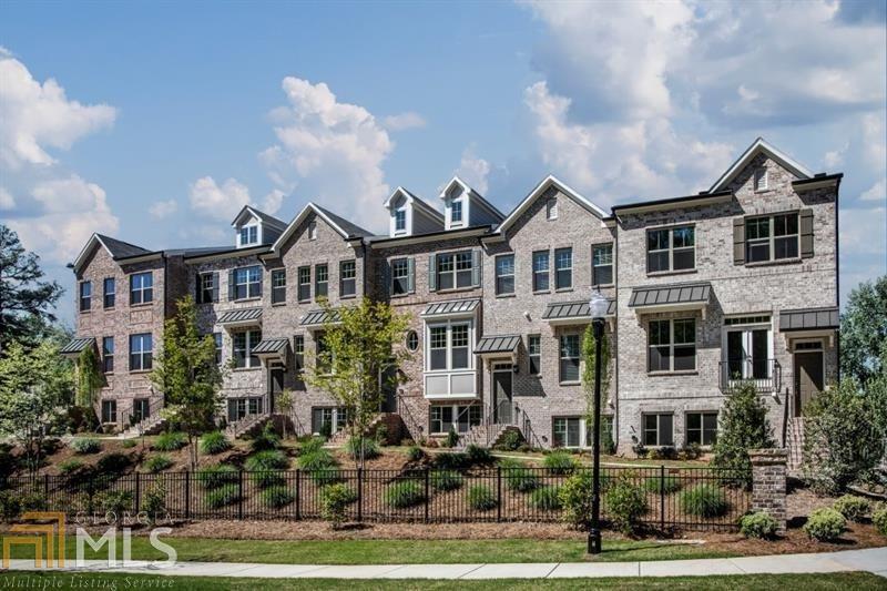 a front view of a residential apartment building with a yard