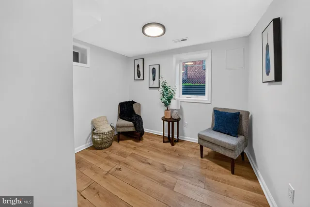 a work room with furniture and wooden floor