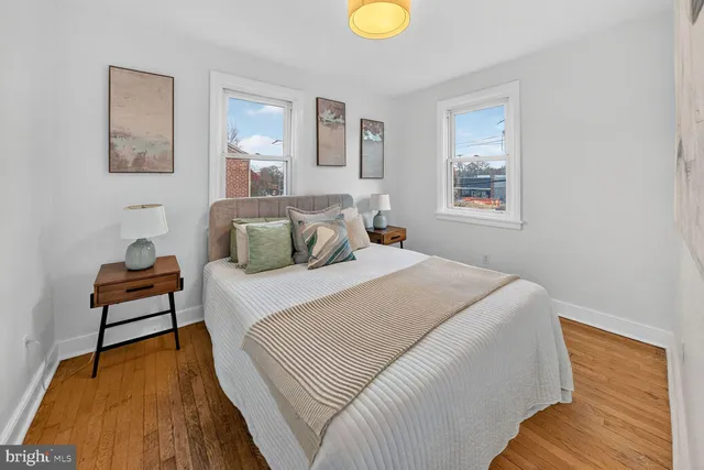 a bedroom with a bed and painting on the wall