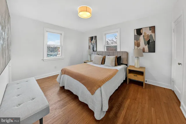 a bedroom with a bed and painting on the wall