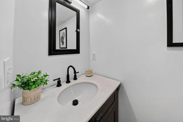 a bathroom with a sink a mirror and vanity