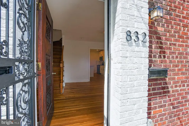a view of a door and brick walls