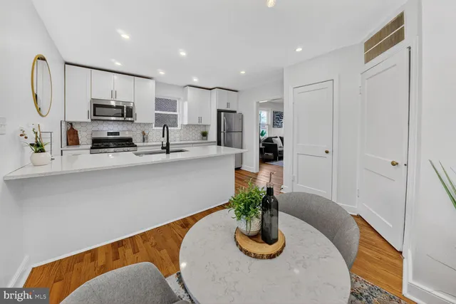 a kitchen with stainless steel appliances granite countertop sink microwave and cabinets