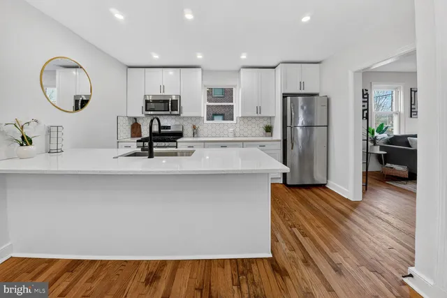 a kitchen with stainless steel appliances a refrigerator and microwave