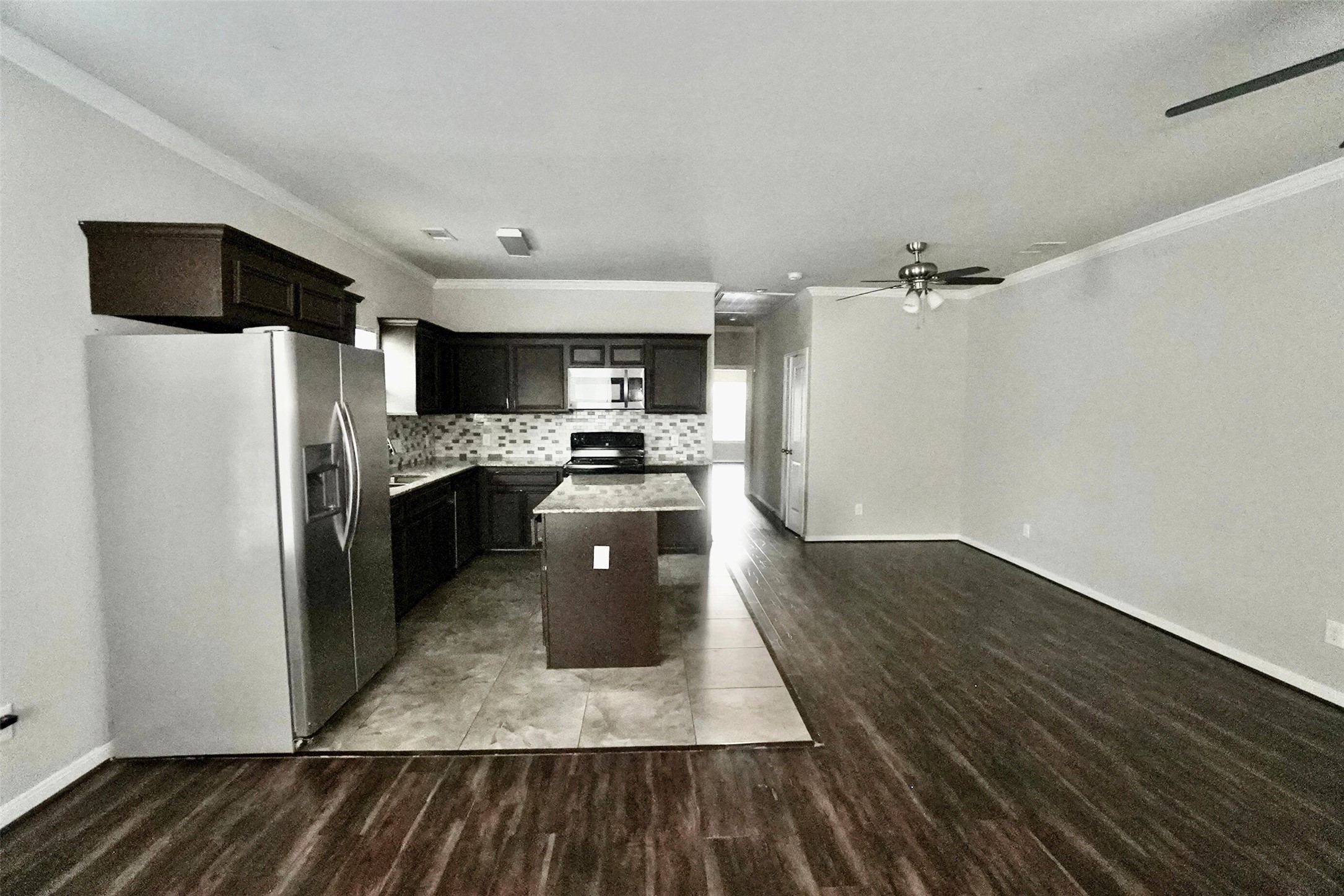 2523 Kirk Street, Unit B Houston, TX 77026 - Photo 5 of 16 a kitchen with granite countertop a refrigerator and a stove top oven