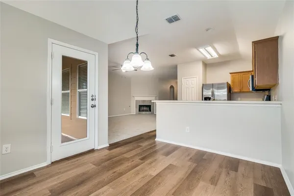 a kitchen with stainless steel appliances granite countertop a refrigerator stove and microwave