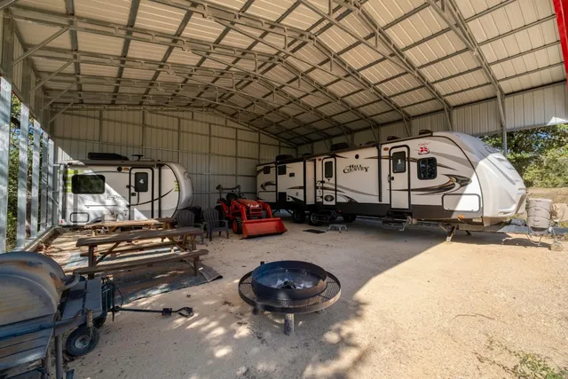a backyard of a house with plants and tree