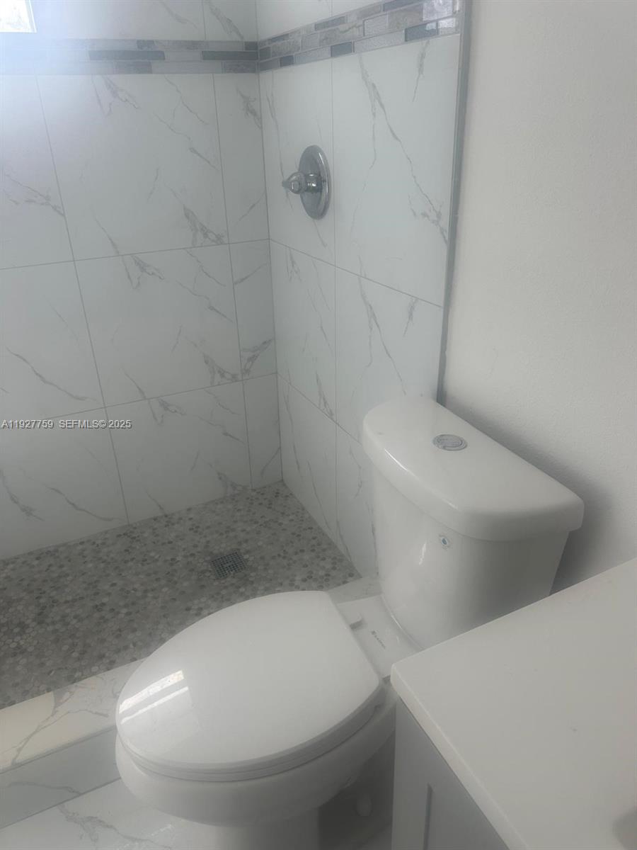 6750 Allen Street Hollywood, FL 33024 - Photo 12 of 79 a bathroom with a toilet and shower