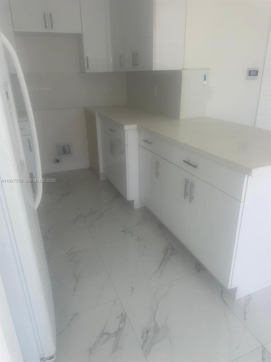 6750 Allen Street Hollywood, FL 33024 - Photo 13 of 79 a view of cabinets and utility room with empty racks