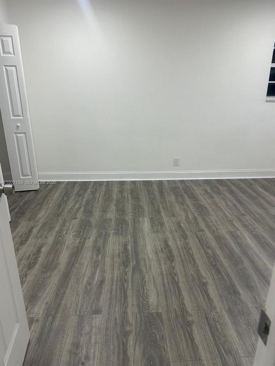 6750 Allen Street Hollywood, FL 33024 - Photo 37 of 79 a view of an empty room with wooden floor and a window
