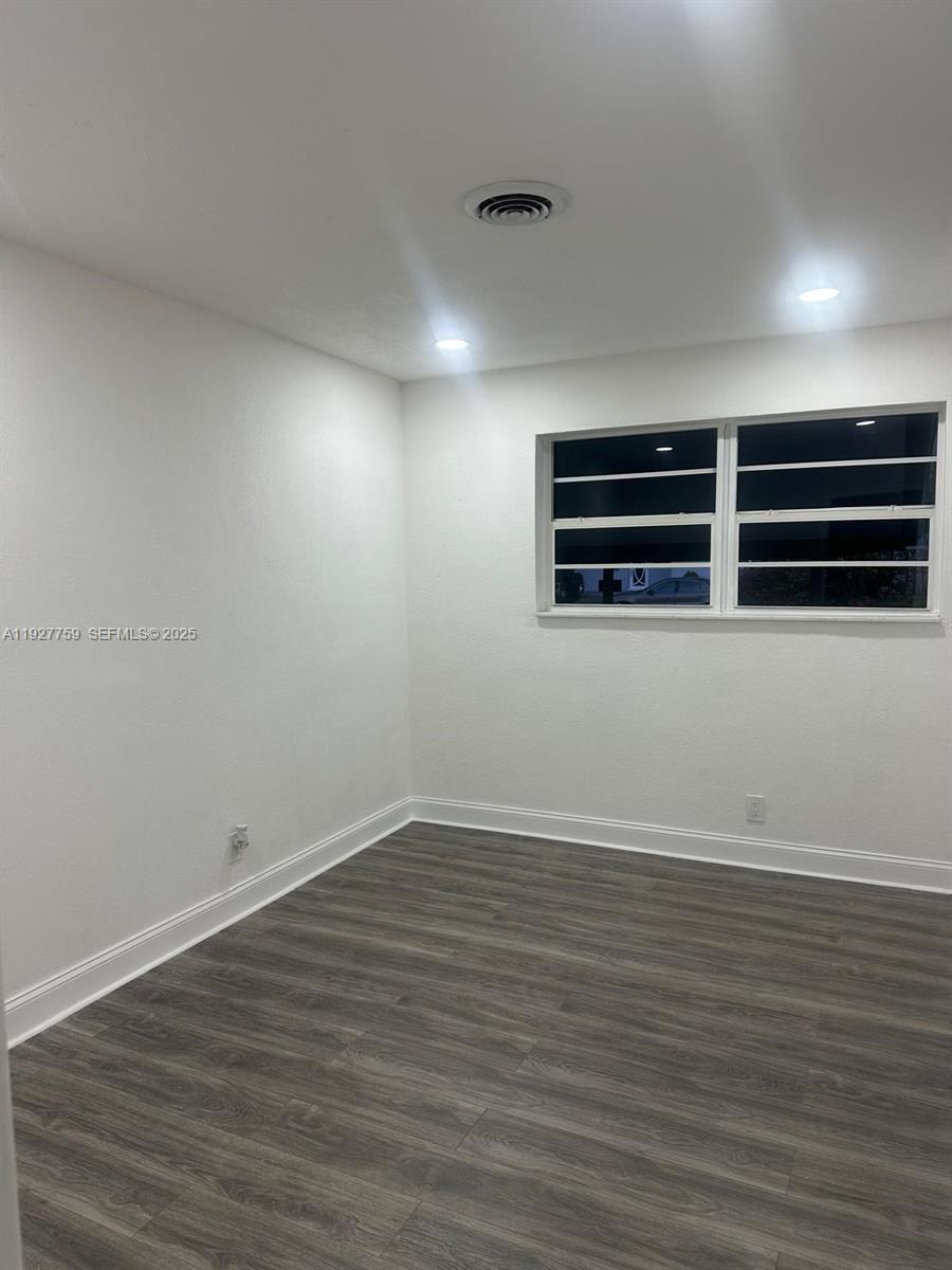 6750 Allen Street Hollywood, FL 33024 - Photo 41 of 79 a view of an empty room with wooden floor and a window