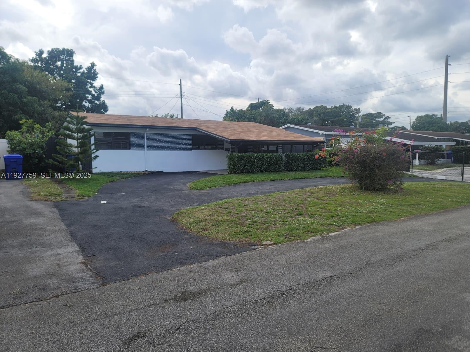 6750 Allen Street Hollywood, FL 33024 - Photo 47 of 79 a view of a house next to a yard with big trees