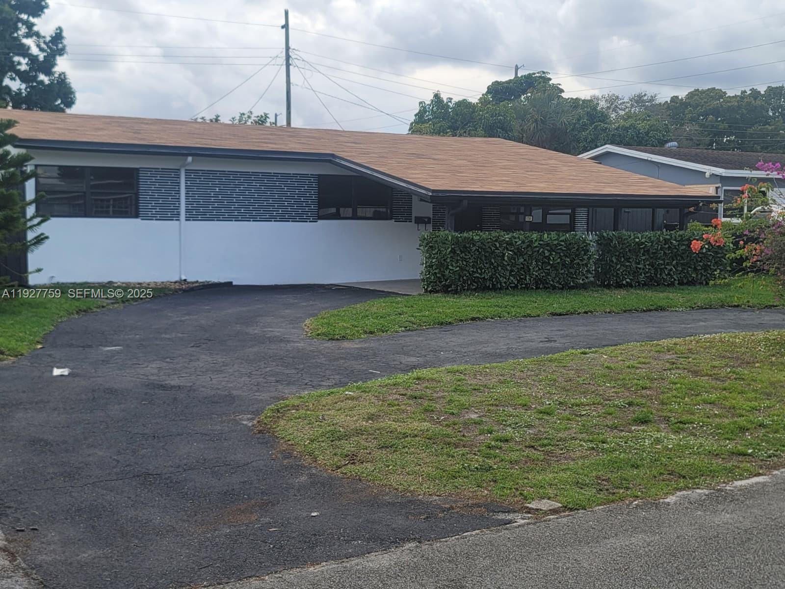 6750 Allen Street Hollywood, FL 33024 - Photo 48 of 79 a front view of a house with a yard