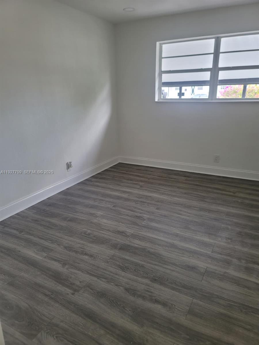 6750 Allen Street Hollywood, FL 33024 - Photo 53 of 79 a view of an empty room with wooden floor and a window