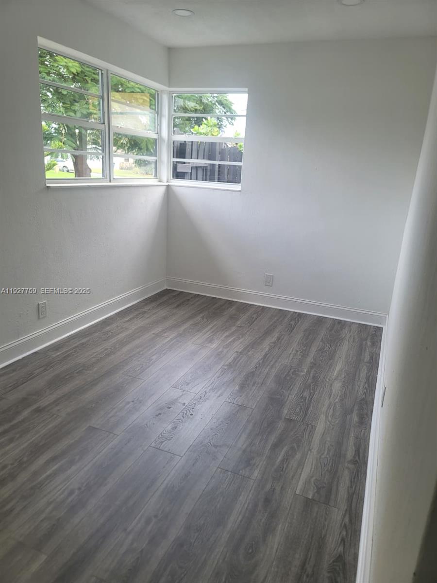 6750 Allen Street Hollywood, FL 33024 - Photo 55 of 79 an empty room with wooden floor and windows