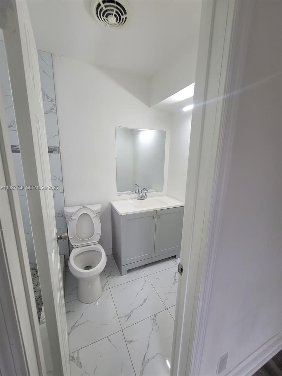 6750 Allen Street Hollywood, FL 33024 - Photo 60 of 79 a bathroom with a sink and a mirror