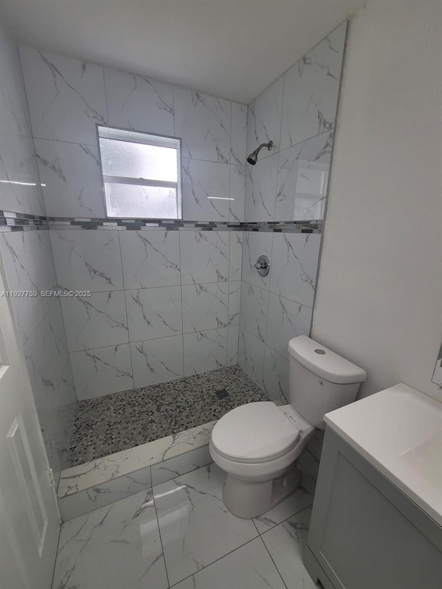 6750 Allen Street Hollywood, FL 33024 - Photo 61 of 79 a white toilet sitting next to a bath tub