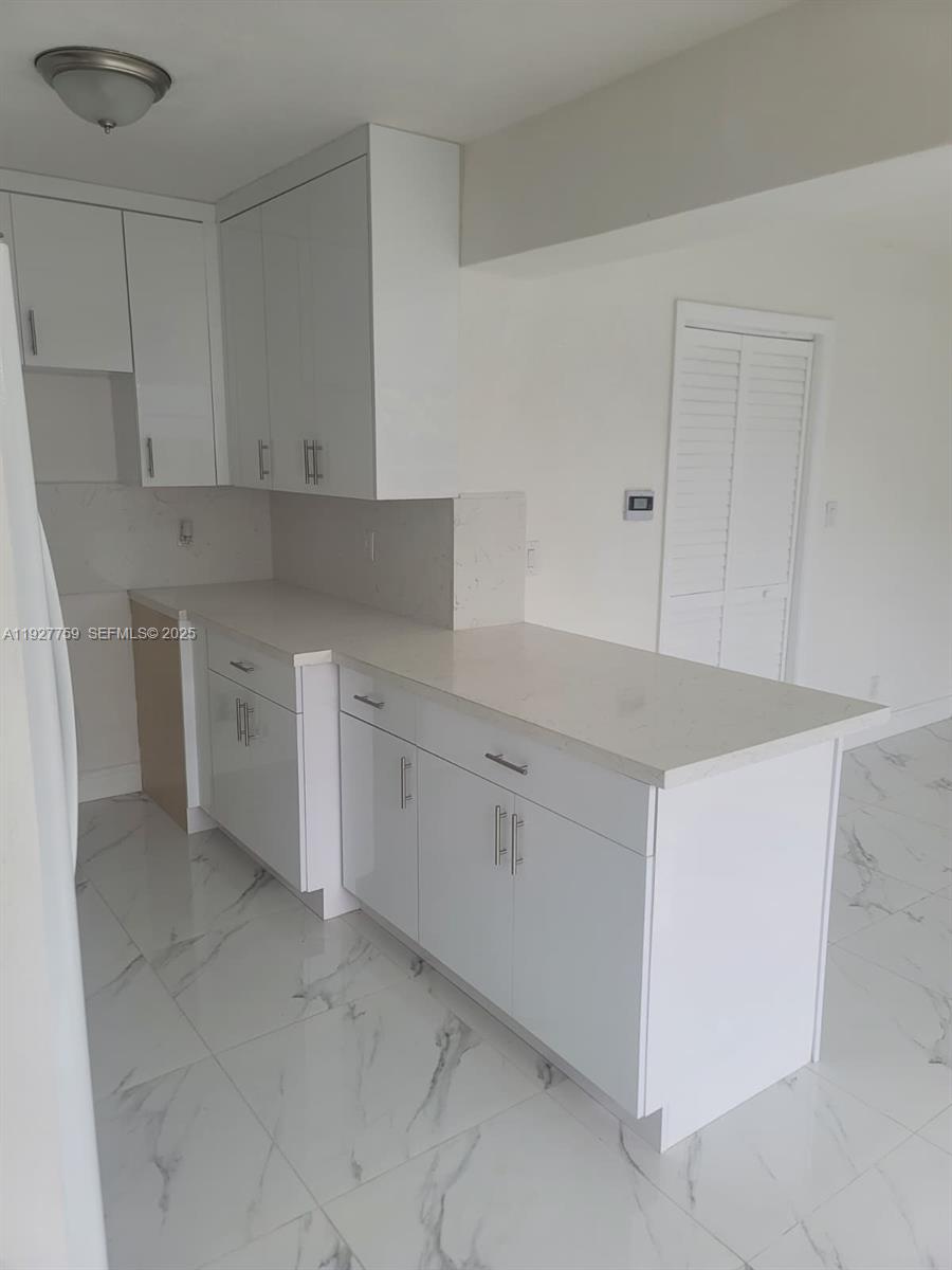 6750 Allen Street Hollywood, FL 33024 - Photo 62 of 79 a kitchen with white cabinets