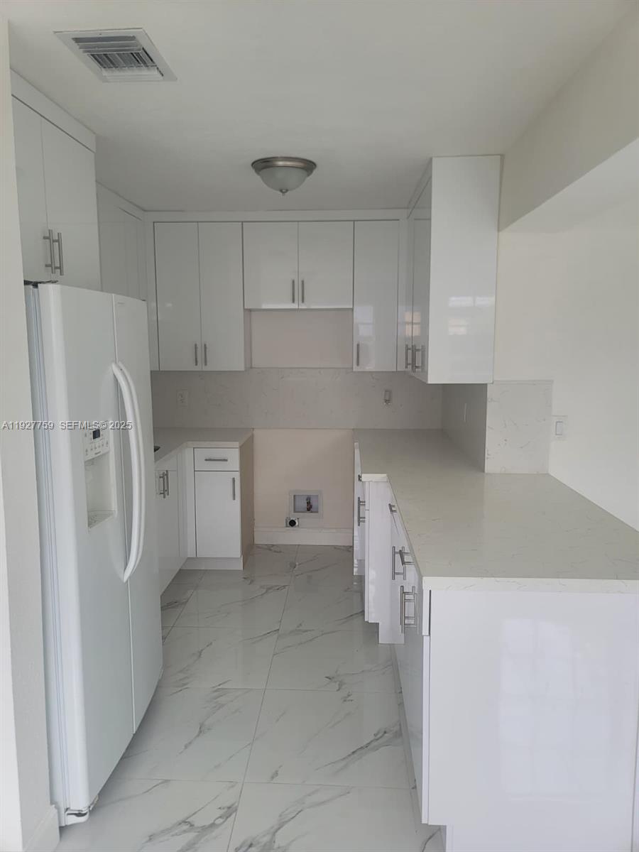 6750 Allen Street Hollywood, FL 33024 - Photo 63 of 79 a kitchen with stainless steel appliances a refrigerator and a sink