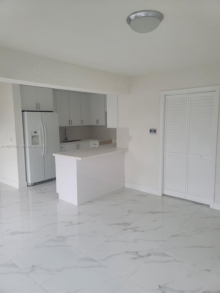 6750 Allen Street Hollywood, FL 33024 - Photo 67 of 79 a view of a kitchen with white cabinets