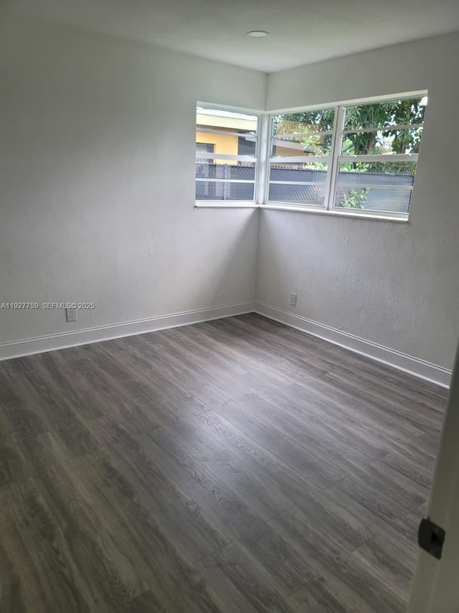 6750 Allen Street Hollywood, FL 33024 - Photo 69 of 79 an empty room with wooden floor and windows