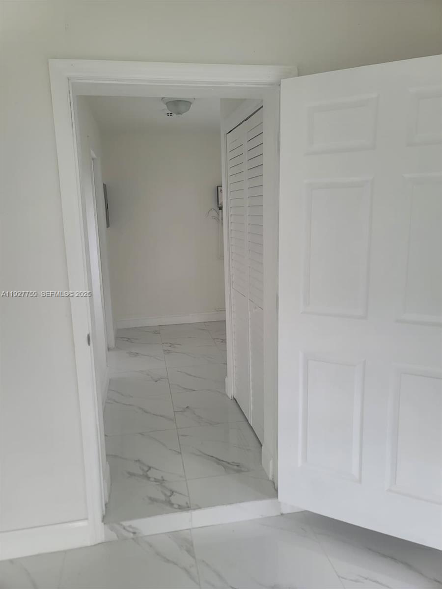 6750 Allen Street Hollywood, FL 33024 - Photo 70 of 79 a bathroom with a glass shower door