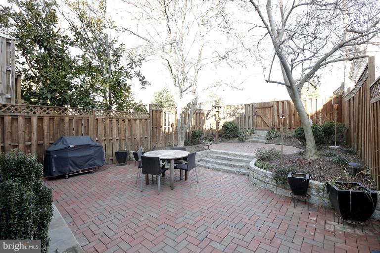 a view of backyard with sitting area and wooden fence